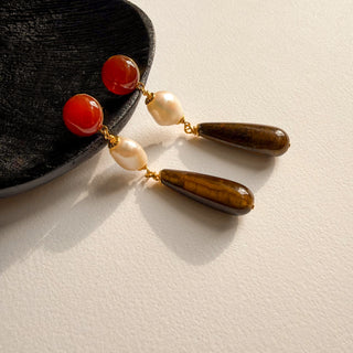 Boucles d'oreilles pendantes oeil de tigre pour oreilles percées ou clips, photo posée.