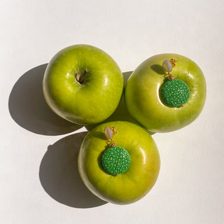 Boucles d’oreilles Grace en galuchat vert, détail posé mettant en valeur la texture du galuchat, la nacre blanche et la finition dorée à l’or fin 24 carats.