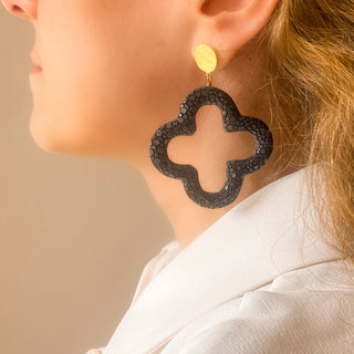 Boucles d’oreilles Trèfle en galuchat noir portées, montrant la longueur totale de 7 cm et la taille du trèfle (5 × 5 cm), disponibles en percées ou clips.