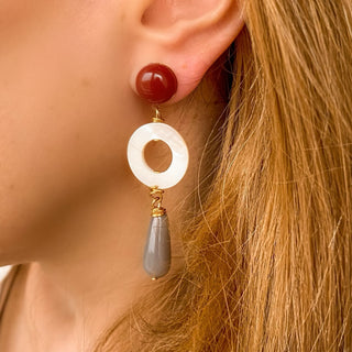 Boucles d’oreilles Louise pendantes dorées en cornaline, agate grise et nacre blanche portées, montrant la longueur, les couleurs naturelles et l’éclat de la dorure, disponibles en percées ou clips. 